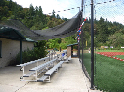 Bleachers and dugout on pavement – greater than 5 feet clear space around them